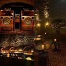 Interior de un local de música o 'listening bar' con grandes altavoces y mesas iluminadas con velas