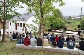 Evento al aire libre en el patio del CAM Lugo con público sentado