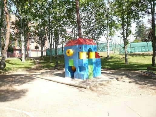Vista del Parque de San Roque con un área infantil colorida y árboles alrededor