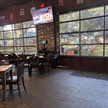Interior del restaurante con mesas y grandes ventanales