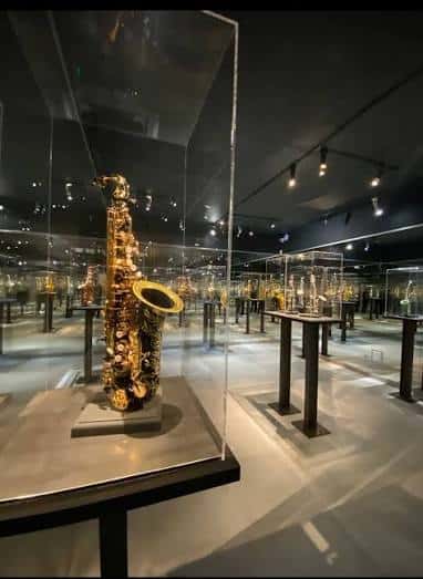 Sala de exposiciones con saxofón dorado en vitrina