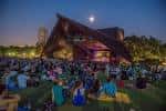Escenario iluminado del teatro durante una función nocturna bajo la luna
