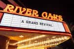 Detalle del cartel luminoso del teatro con texto 'A Grand Revival'