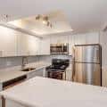 Vista amplia de la cocina con encimeras blancas y iluminación empotrada