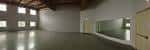 Interior amplio del teatro con grandes ventanales y paredes blancas