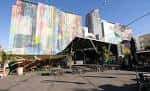 Vista exterior del Quartyard con fachada de arte urbano y escenario al aire libre