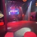 Escenario principal con luces de colores y pantalla LED durante una presentación en vivo