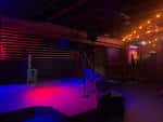 Escenario vacío del Sunset Tavern con iluminación de colores