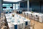 Salón principal preparado para una cena formal con mantelería blanca