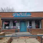 Vista exterior del local Petra's en Charlotte con su letrero distintivo
