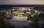 Vista nocturna del Morton Amphitheater con escenario iluminado y público en el área de césped