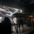 DJ actuando en el escenario de REALM PDX con pantalla de fondo