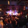Público disfrutando de un show en el interior del club con iluminación ambiental