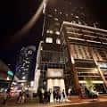 Fachada nocturna del edificio de Hand Cut en Nashville con iluminación urbana y actividad peatonal