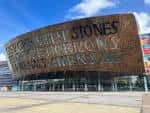 Vista exterior del Wales Millennium Centre con fachada de cobre y letras en inglés