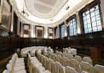 Sala de eventos interior del Merchants House con mesas y sillas blancas dispuestas para una celebración