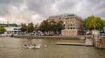 Vista panorámica del Arnolfini desde el río con embarcaciones y cielo nublado