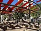Estructura moderna de techo rojo en la plaza, ideal para eventos al aire libre
