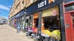 Fachada exterior de R-CADE en Glasgow con mesas al aire libre