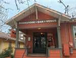 Fachada exterior de The Wild Detectives con letrero que indica 'Bookstore • Bar • Venue'