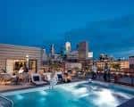 Vista nocturna de la piscina en la azotea del Hewing Hotel con vistas a Minneapolis