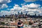 Pareja celebrando una propuesta con la skyline de Filadelfia al fondo