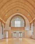 Interior del Binks Hall con techo abovedado de madera y grandes ventanales góticos