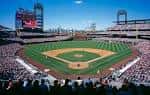 Campo de juego en día soleado con espectadores en las tribunas