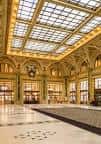 Gran salón principal con techo de cristal y arquitectura clásica