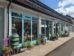 Fachada de tiendas del mercado con escaparates y macetas decorativas