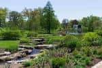 Jardín paisajístico con arroyo y vegetación exuberante