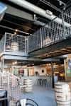 Espacio interior industrial con barriles de cerveza y estructura metálica
