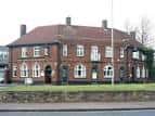 Vista exterior del Portland Arms en Cambridge, edificio histórico de ladrillo con fachada clásica