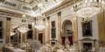 Salón interior decorado para boda con arañas de cristal y mesas dispuestas