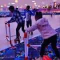 Niños patinando en pista interior con luces de colores