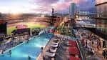 Vista panorámica de Ballpark Village al atardecer con piscina y zona de eventos