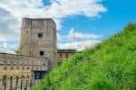 Torre principal del castillo con vegetación verde en primer plano
