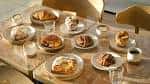 Mesa con variedad de postres y café en ambiente elegante
