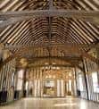 Gran salón interior del Dragon Hall con techumbre de vigas de madera expuesta y suelo pulido