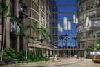 Vista exterior del hotel Westshore Grand con fachada moderna y palmeras