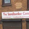Señal exterior del Sandbunker Community Centre con nombre y contacto