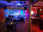 Escenario iluminado en el Arts Bar Baltic durante un evento nocturno