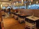 Interior del restaurante con mesas dispuestas para eventos y decoración moderna