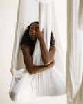 Sala de práctica con hamacas blancas suspendidas para yoga o breathwork