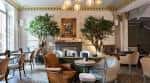 Sala de eventos con decoración elegante, chimenea y plantas ornamentales