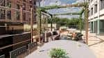 Terraza exterior con mobiliario y estructura vegetal, ideal para eventos al aire libre