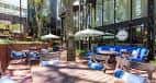 Terraza exterior de Che Vita con mobiliario cómodo y sombrillas, ideal para celebraciones al aire libre