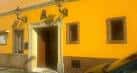 Fachada exterior de la Asociación Cultural Flamenca Fernando Terremoto con paredes amarillas y entrada principal