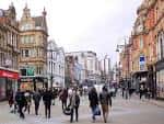 Briggate en Leeds durante el día, mostrando arquitectura victoriana y tiendas