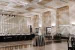 Gran salón preparado para un evento con iluminación elegante